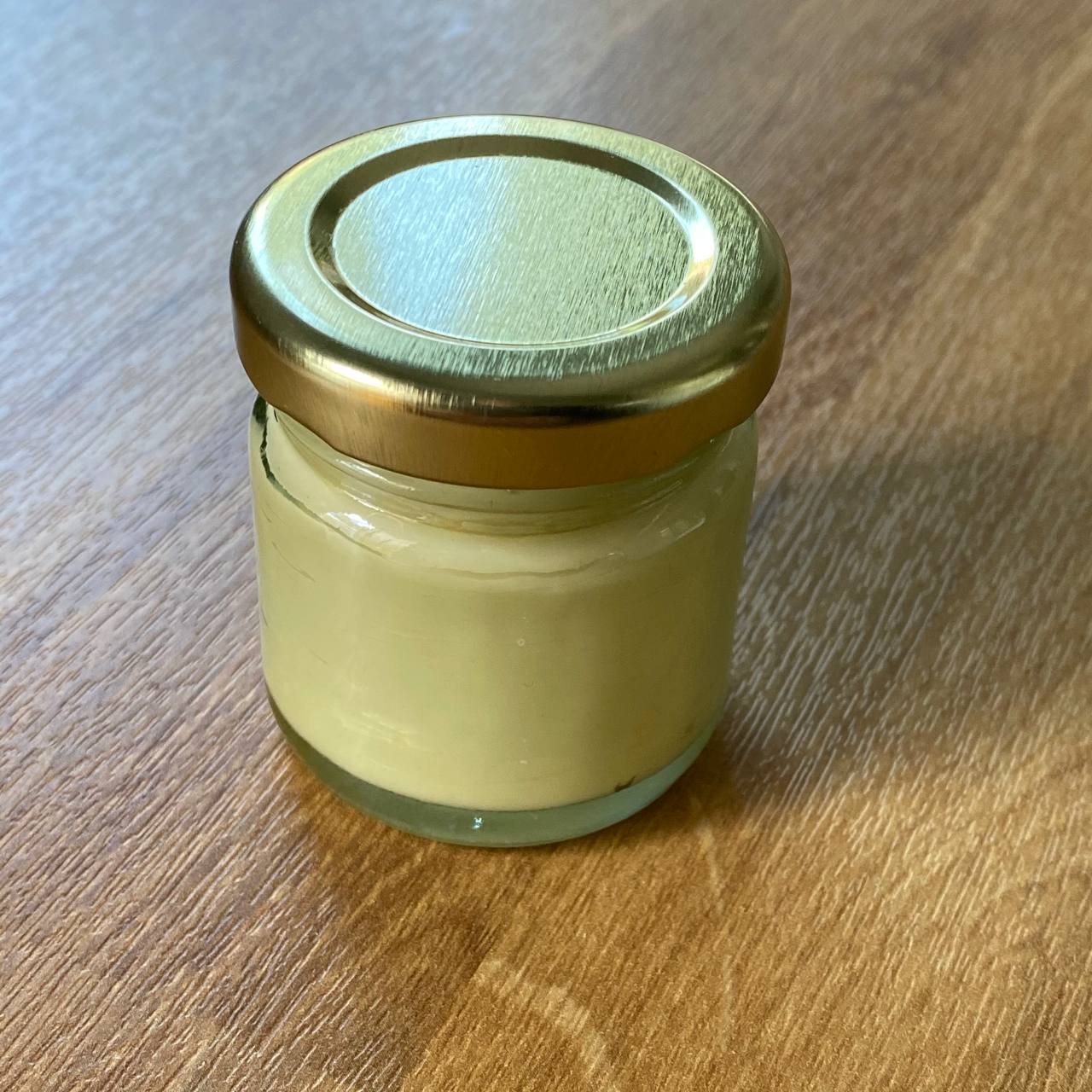 A homemade healing balm made with daisies